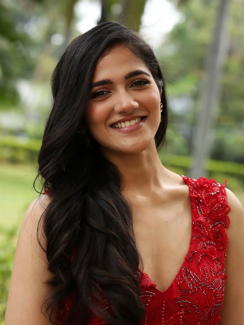 telugu actress simran choudhary  long hair smiling face in red dress